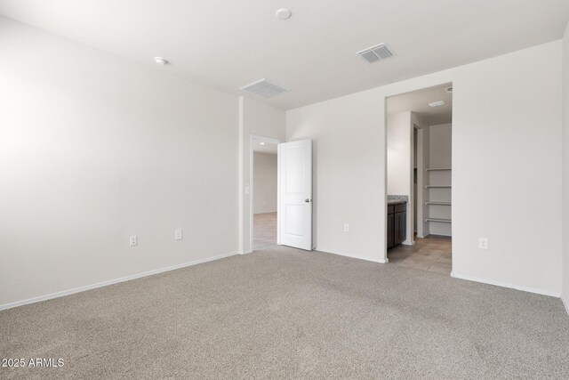 5269 E Gummite Dr, San Tan Valley, AZ 85143 - unfurnished bedroom with light carpet, baseboards, and visible vents