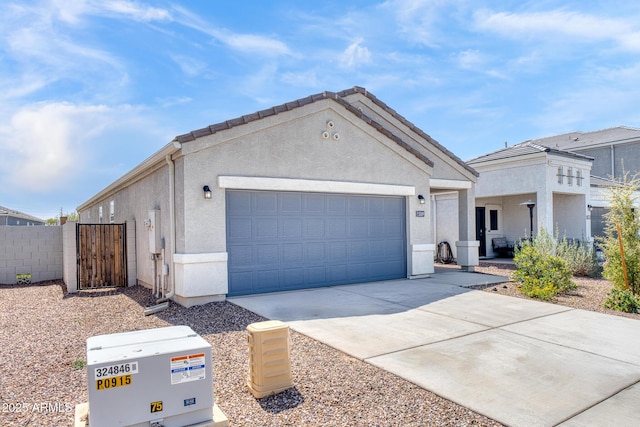 5269 E Gummite Dr, San Tan Valley, AZ 85143 - view of front of home with driveway, a garage, fence, and stucco siding