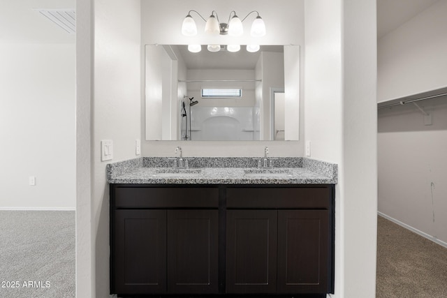 5269 E Gummite Dr, San Tan Valley, AZ 85143 - full bath featuring double vanity, a shower, baseboards, and a sink