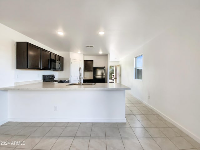 kitchen with black appliances, sink, dark brown cabinets, light tile patterned flooring, and kitchen peninsula