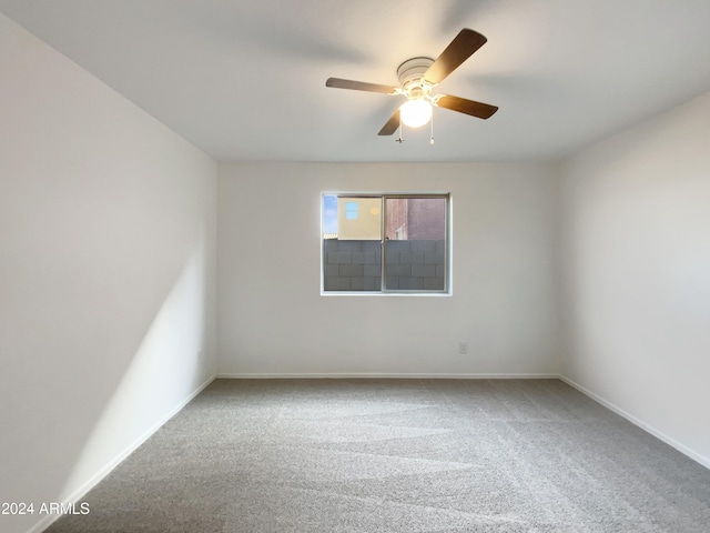 unfurnished room with carpet flooring and ceiling fan