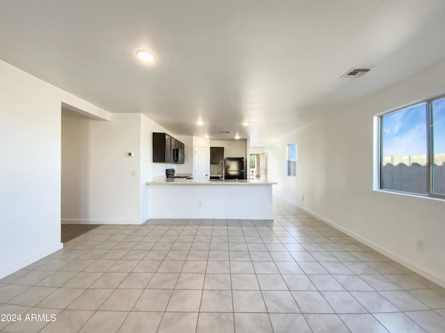 unfurnished living room with light tile patterned flooring