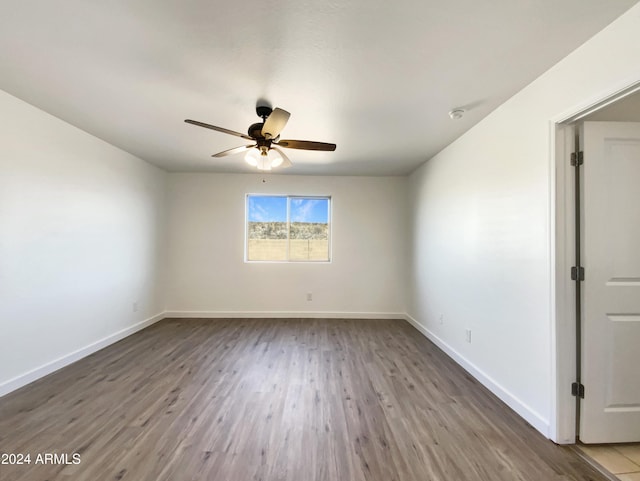 spare room featuring hardwood / wood-style flooring and ceiling fan