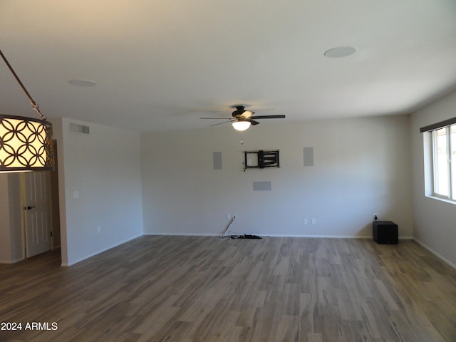 unfurnished living room featuring hardwood / wood-style floors and ceiling fan