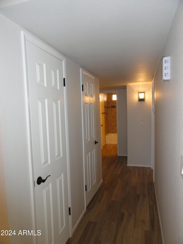 hall with dark hardwood / wood-style flooring