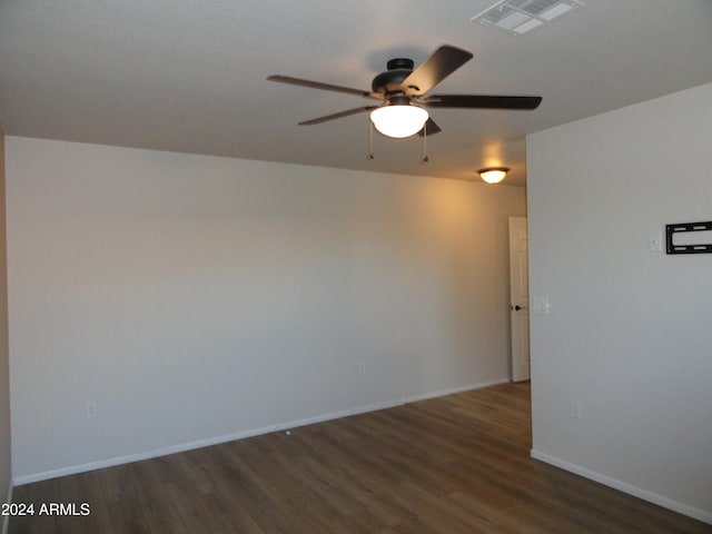 empty room featuring ceiling fan and dark wood-type flooring