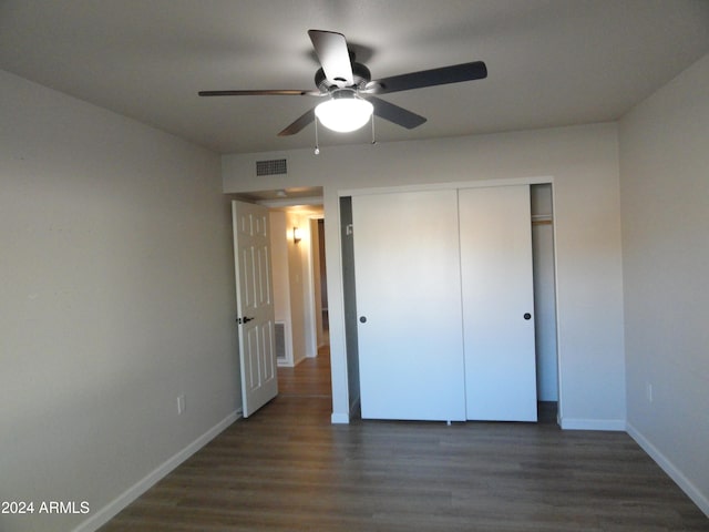 unfurnished bedroom featuring ceiling fan, a closet, and dark hardwood / wood-style floors