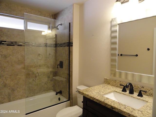 full bathroom featuring vanity, toilet, and tiled shower / bath