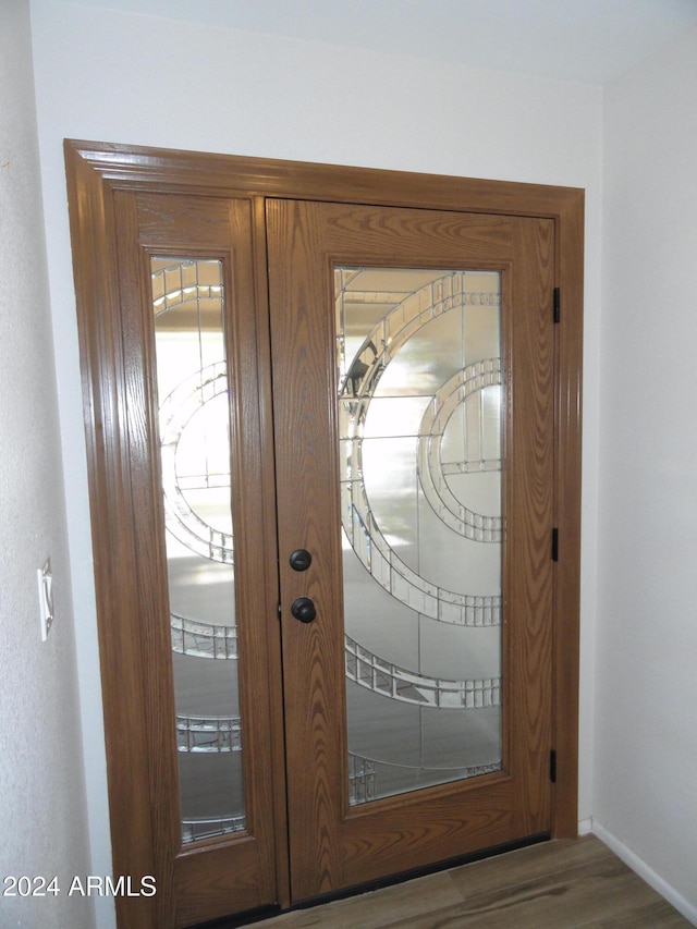 entryway with french doors and dark hardwood / wood-style flooring