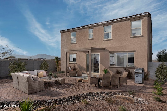 back of house with a patio, a mountain view, and an outdoor hangout area