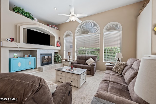 living area featuring recessed lighting, light colored carpet, a ceiling fan, and a tile fireplace