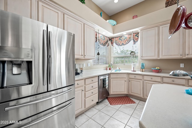 kitchen with appliances with stainless steel finishes, light countertops, and light tile patterned floors