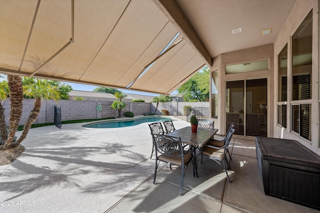 view of patio with a fenced backyard, a fenced in pool, and outdoor dining space