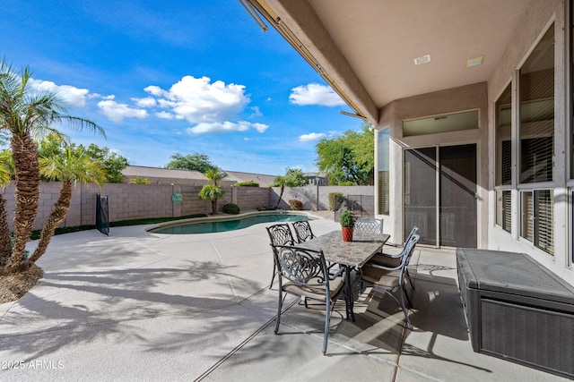 view of patio / terrace with a fenced in pool, outdoor dining space, and a fenced backyard