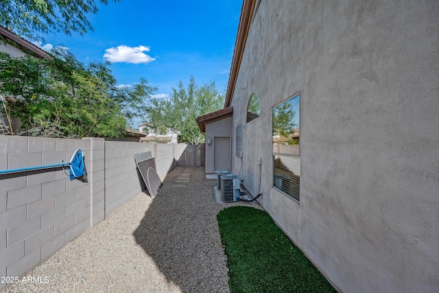 view of yard with a fenced backyard and cooling unit