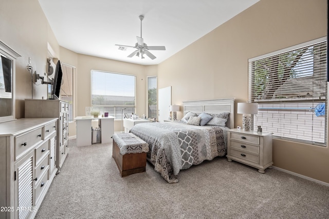 bedroom with light carpet, ceiling fan, visible vents, and baseboards