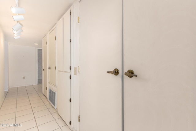 corridor featuring visible vents and light tile patterned floors