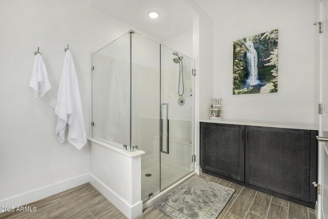 1567 W Camina Plata, San Tan Valley, AZ 85140 - bathroom featuring wood tiled floors and a shower stall