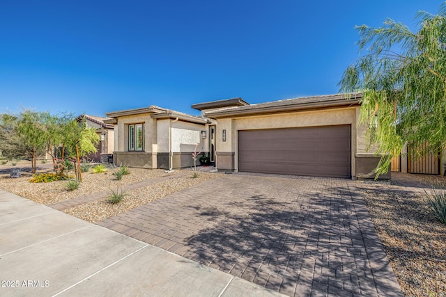 1567 W Camina Plata, San Tan Valley, AZ 85140 - prairie-style home with stucco siding, decorative driveway, an attached garage, and a tile roof