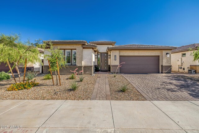 1567 W Camina Plata, San Tan Valley, AZ 85140 - prairie-style home featuring stucco siding, an attached garage, decorative driveway, and a tiled roof