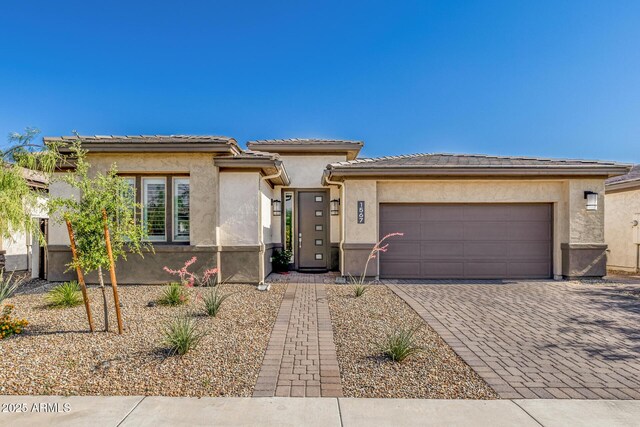 1567 W Camina Plata, San Tan Valley, AZ 85140 - prairie-style home featuring decorative driveway, a garage, and stucco siding