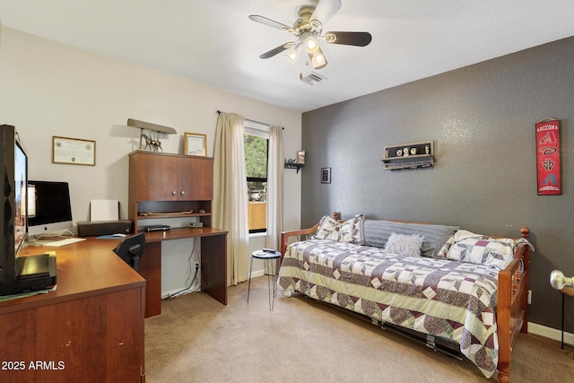 bedroom featuring baseboards, visible vents, ceiling fan, light carpet, and a textured wall