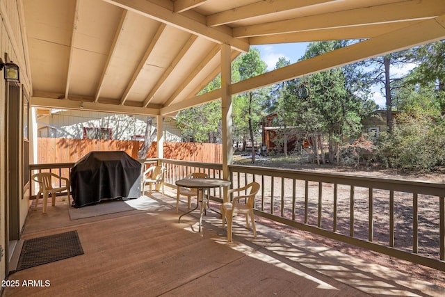 wooden deck with area for grilling and fence