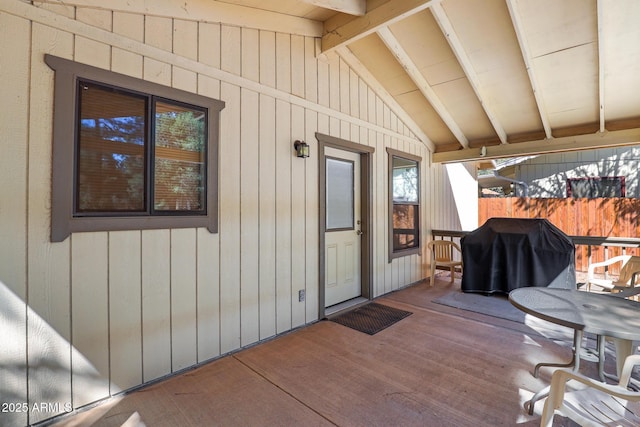 exterior space with a grill, a wooden deck, and fence