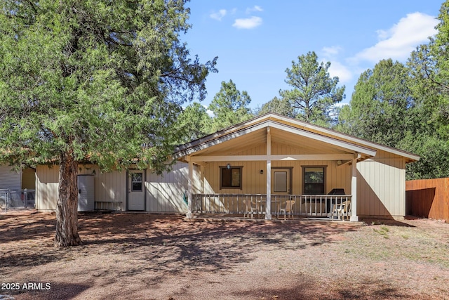 view of front of house with a porch and fence