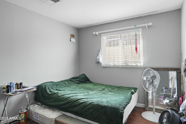 bedroom with dark hardwood / wood-style flooring