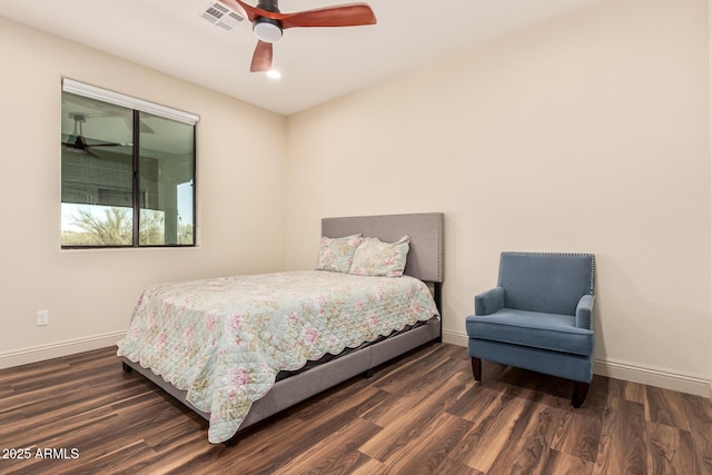 bedroom featuring a ceiling fan, wood finished floors, visible vents, and baseboards