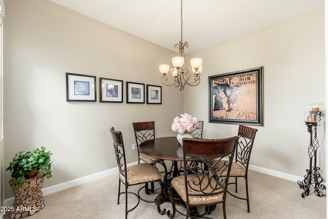 dining room featuring light carpet, a chandelier, and baseboards