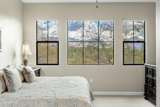 carpeted bedroom featuring baseboards