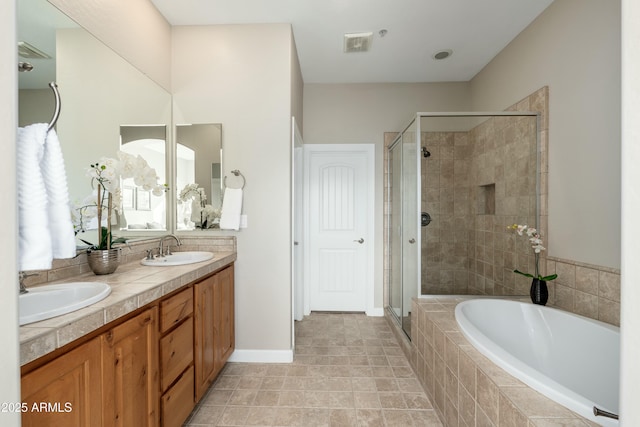 full bath with double vanity, a sink, a shower stall, and a bath