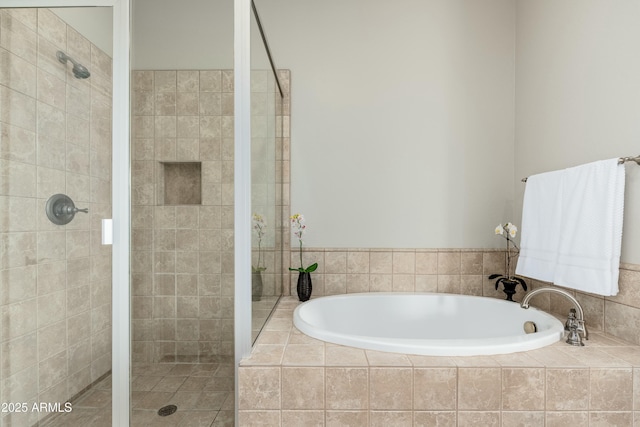 bathroom with a shower stall and a bath