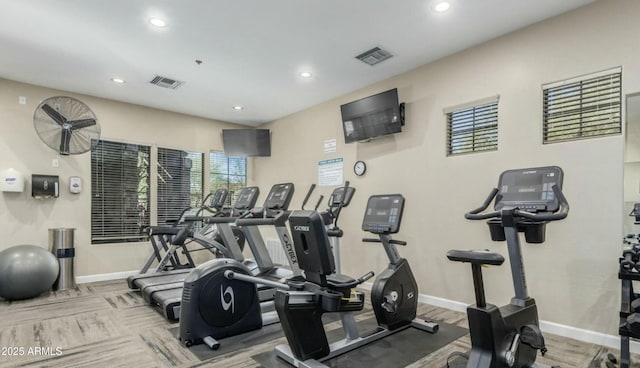 gym featuring visible vents, baseboards, and wood finished floors