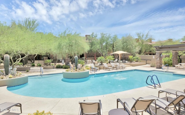 community pool featuring a patio area and fence