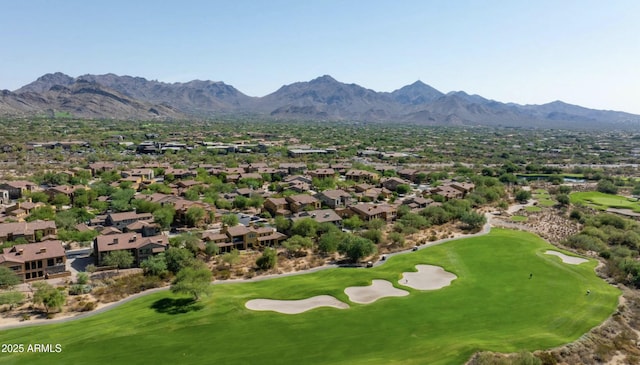 drone / aerial view with view of golf course and a mountain view