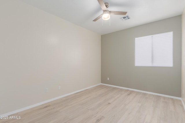 spare room featuring light hardwood / wood-style floors and ceiling fan