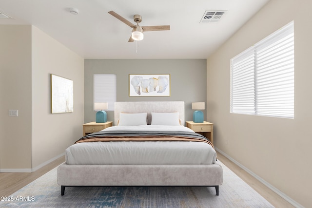 bedroom with ceiling fan and light hardwood / wood-style floors