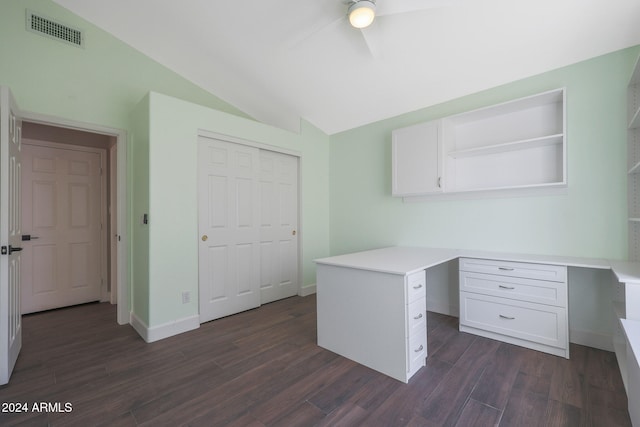 unfurnished office with built in desk, ceiling fan, vaulted ceiling, and dark hardwood / wood-style flooring