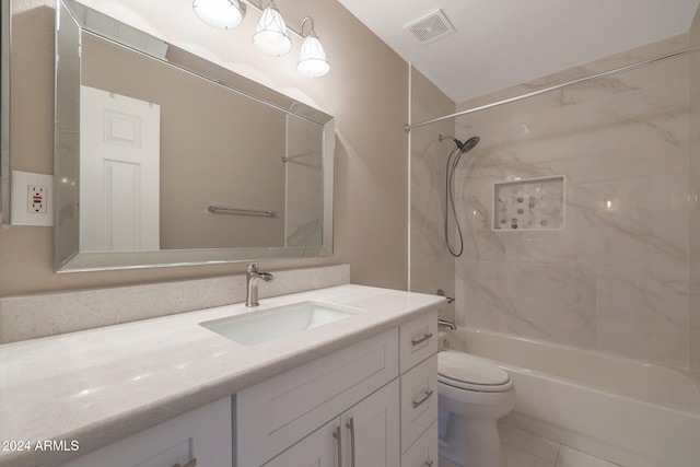 full bathroom with tile patterned floors, vanity, tiled shower / bath combo, and toilet