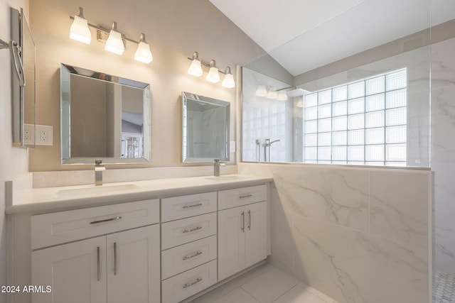 bathroom featuring tile walls, tile patterned floors, vanity, a shower, and lofted ceiling