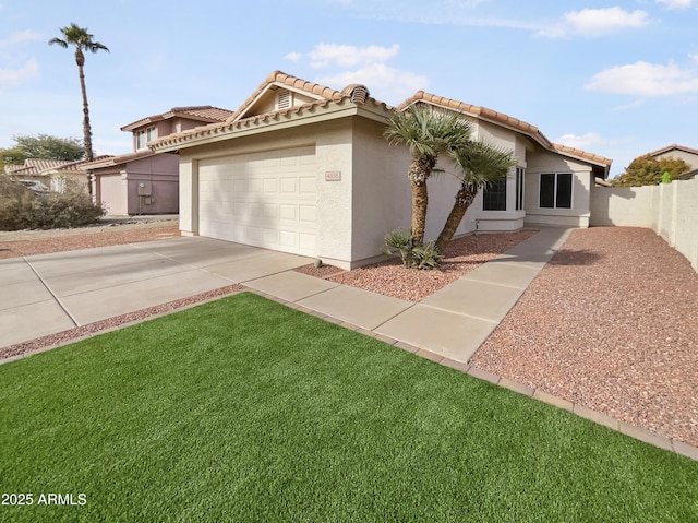 mediterranean / spanish house featuring a front yard and a garage