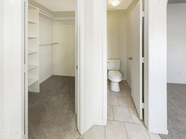 bathroom featuring tile patterned flooring and toilet