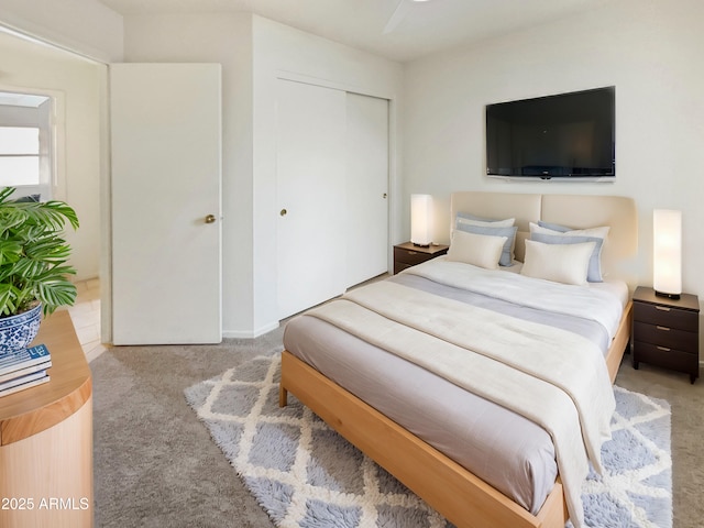 bedroom featuring light carpet and a closet