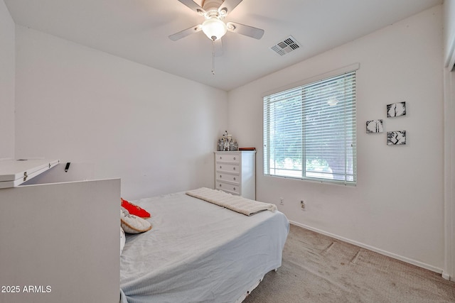 bedroom with visible vents, baseboards, ceiling fan, and light carpet
