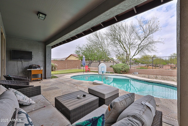 view of pool with a patio, a fenced backyard, a fenced in pool, and an outdoor living space