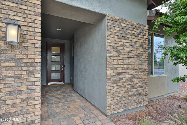 view of exterior entry with stucco siding