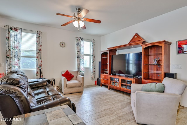 living area with ceiling fan and light wood-style floors